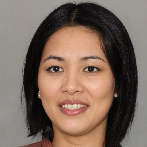 Joyful asian young-adult female with medium  black hair and brown eyes