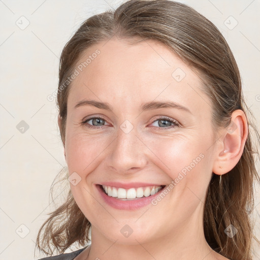 Joyful white young-adult female with medium  brown hair and blue eyes