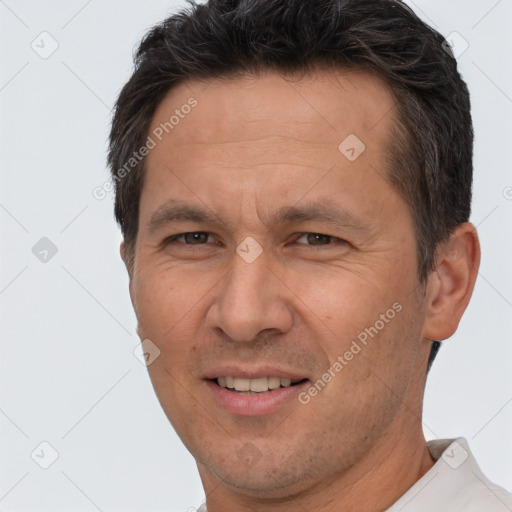 Joyful white adult male with short  brown hair and brown eyes