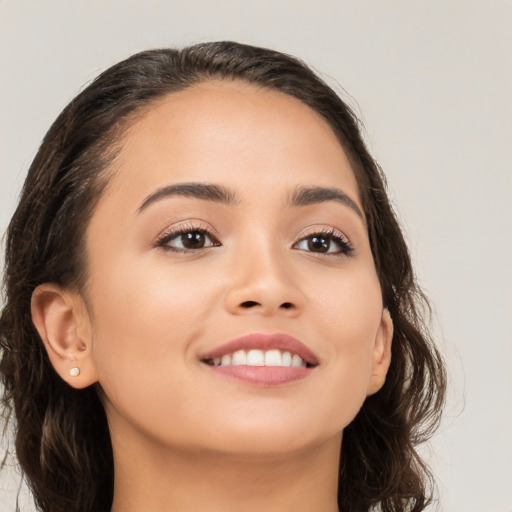 Joyful white young-adult female with long  brown hair and brown eyes