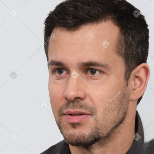 Joyful white adult male with short  black hair and brown eyes