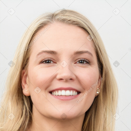 Joyful white young-adult female with long  brown hair and blue eyes