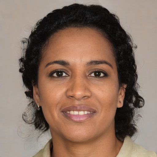 Joyful black young-adult female with medium  black hair and brown eyes