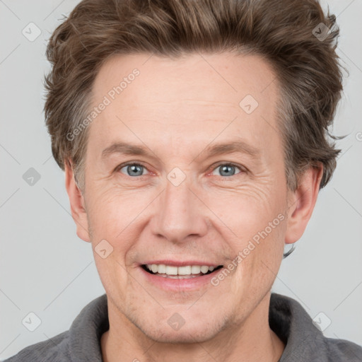 Joyful white adult male with short  brown hair and grey eyes