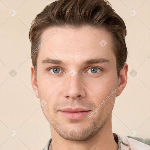 Joyful white young-adult male with short  brown hair and grey eyes