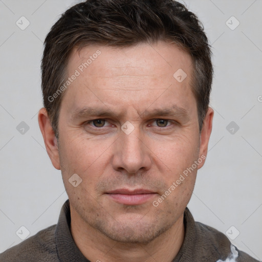 Joyful white adult male with short  brown hair and grey eyes