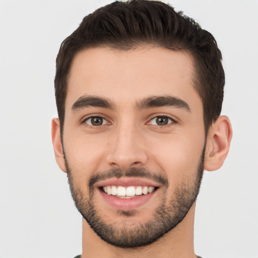 Joyful white young-adult male with short  black hair and brown eyes