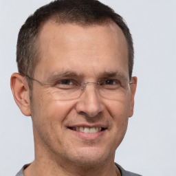 Joyful white adult male with short  brown hair and brown eyes