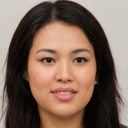 Joyful asian young-adult female with long  brown hair and brown eyes
