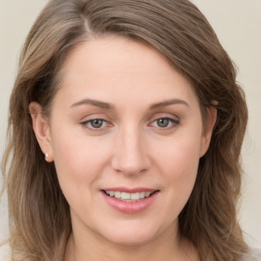 Joyful white young-adult female with long  brown hair and grey eyes