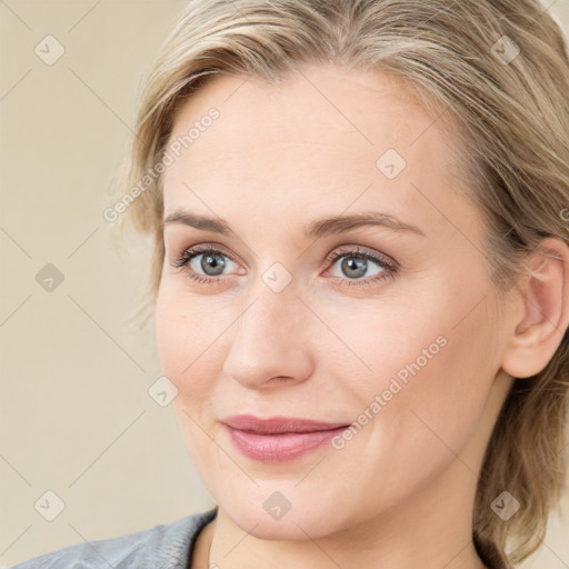 Joyful white young-adult female with medium  brown hair and blue eyes