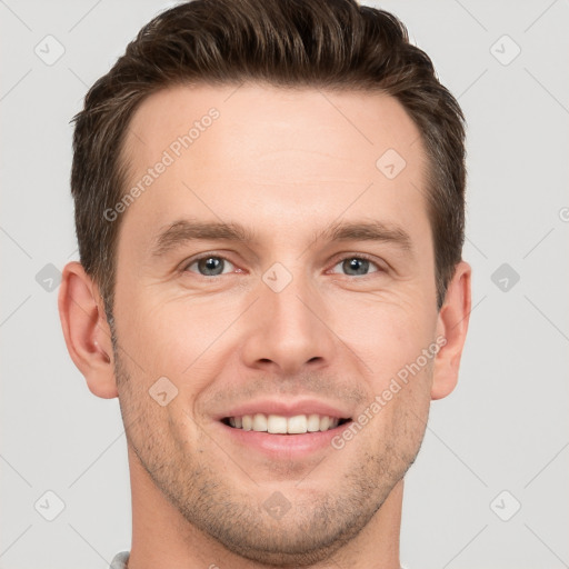 Joyful white young-adult male with short  brown hair and grey eyes