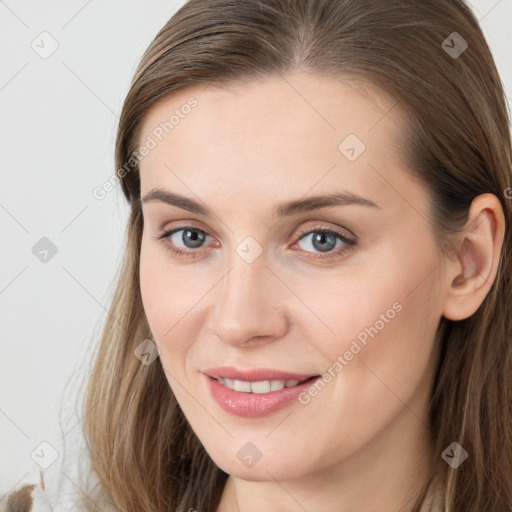 Joyful white young-adult female with long  brown hair and grey eyes