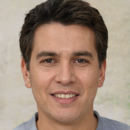 Joyful white adult male with short  brown hair and brown eyes