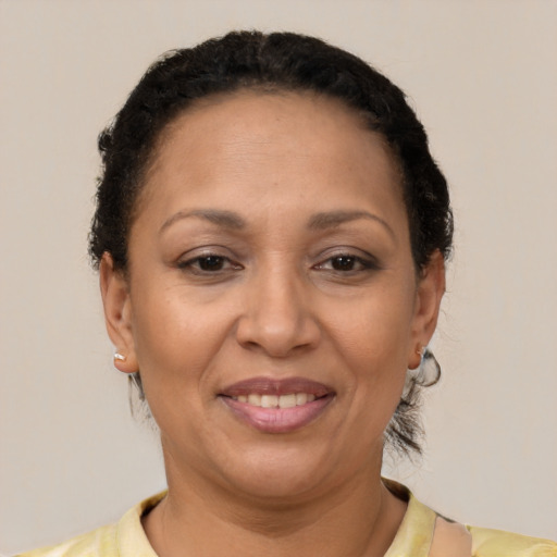 Joyful latino adult female with short  brown hair and brown eyes