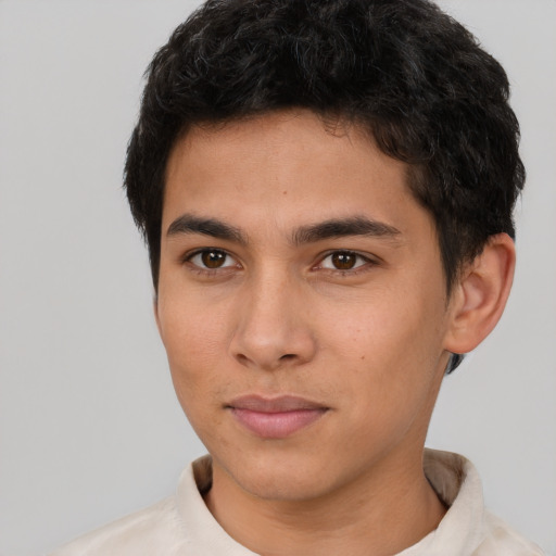 Joyful latino young-adult male with short  brown hair and brown eyes