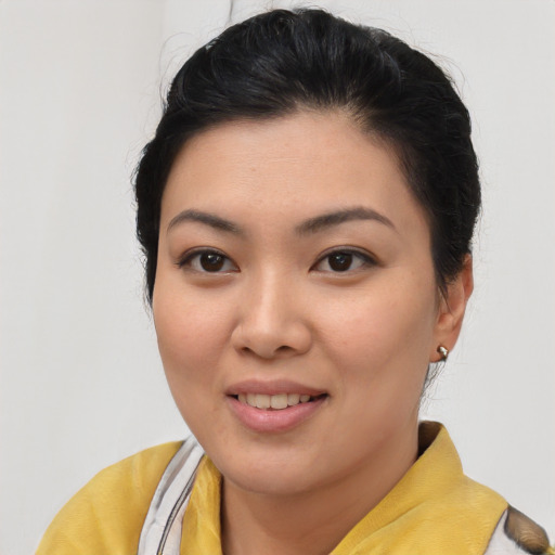 Joyful asian young-adult female with short  brown hair and brown eyes