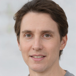 Joyful white adult male with short  brown hair and grey eyes