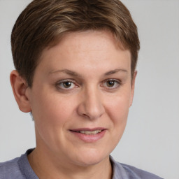 Joyful white young-adult female with short  brown hair and grey eyes