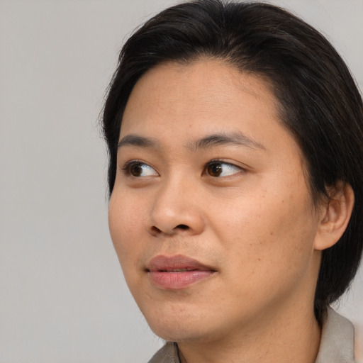 Joyful asian young-adult female with medium  brown hair and brown eyes