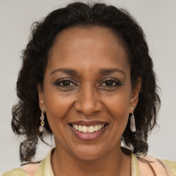 Joyful latino adult female with long  brown hair and brown eyes