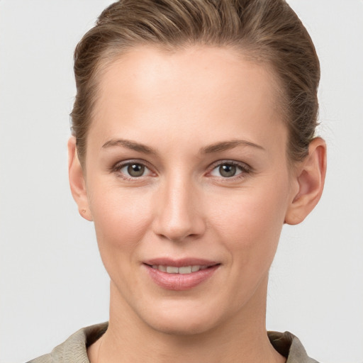 Joyful white young-adult female with short  brown hair and grey eyes