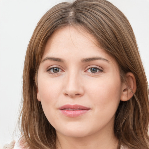 Joyful white young-adult female with long  brown hair and grey eyes