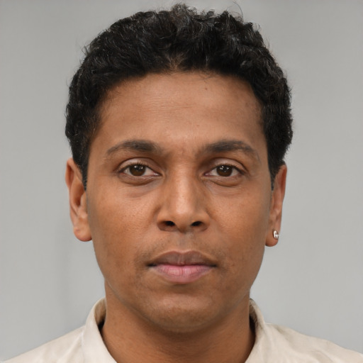 Neutral latino young-adult male with short  brown hair and brown eyes