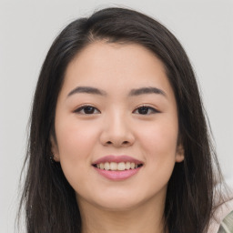 Joyful asian young-adult female with long  brown hair and brown eyes