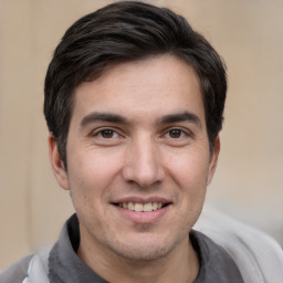 Joyful white young-adult male with short  black hair and brown eyes