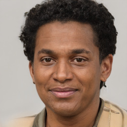 Joyful black adult male with short  brown hair and brown eyes