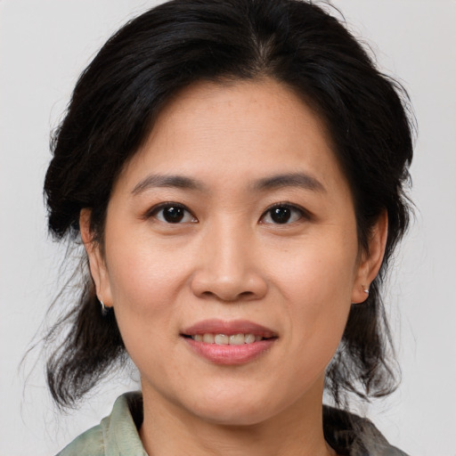 Joyful asian young-adult female with medium  brown hair and brown eyes