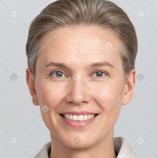 Joyful white adult female with short  brown hair and grey eyes