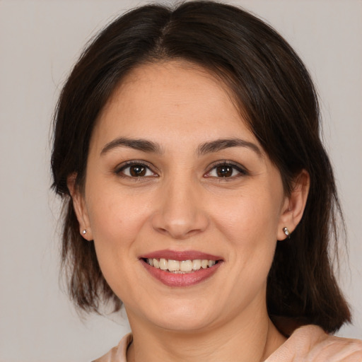 Joyful white young-adult female with medium  brown hair and brown eyes