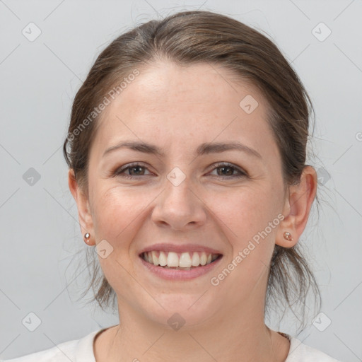 Joyful white young-adult female with medium  brown hair and grey eyes