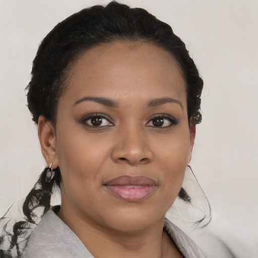 Joyful black young-adult female with medium  brown hair and brown eyes
