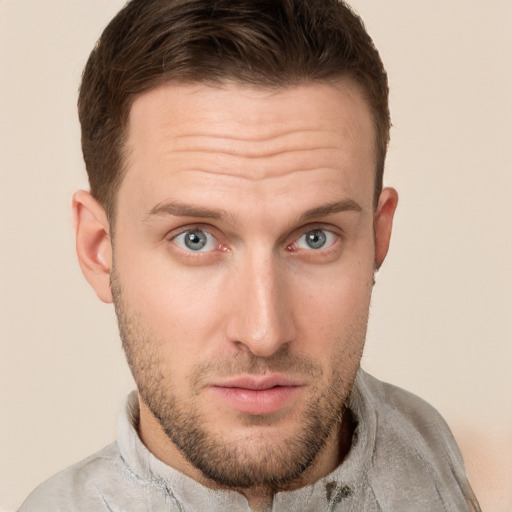 Joyful white young-adult male with short  brown hair and grey eyes