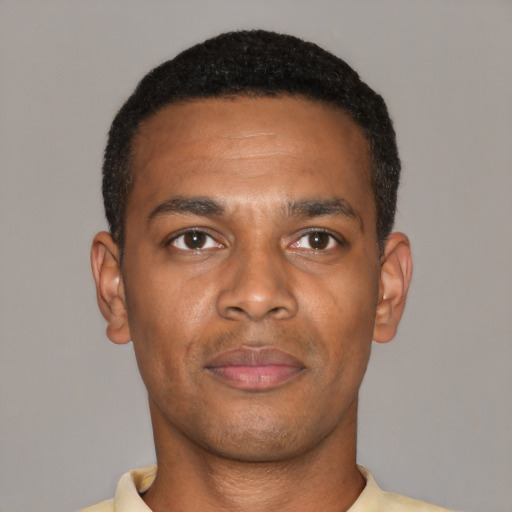 Joyful black young-adult male with short  black hair and brown eyes
