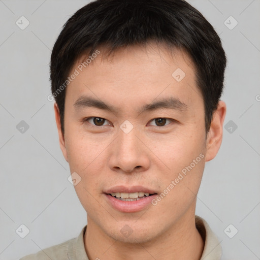 Joyful asian young-adult male with short  brown hair and brown eyes