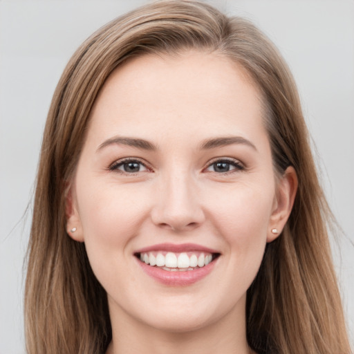 Joyful white young-adult female with long  brown hair and grey eyes