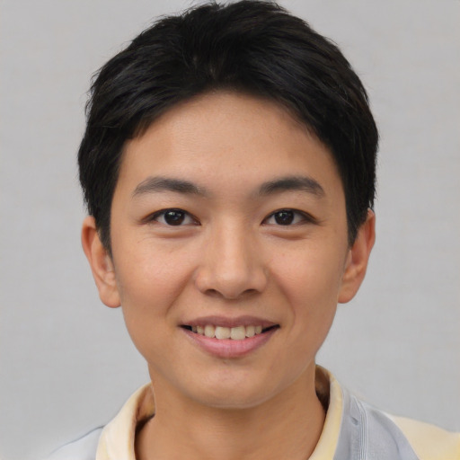Joyful asian young-adult female with short  black hair and brown eyes
