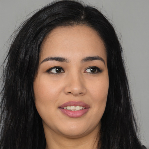 Joyful asian young-adult female with long  brown hair and brown eyes