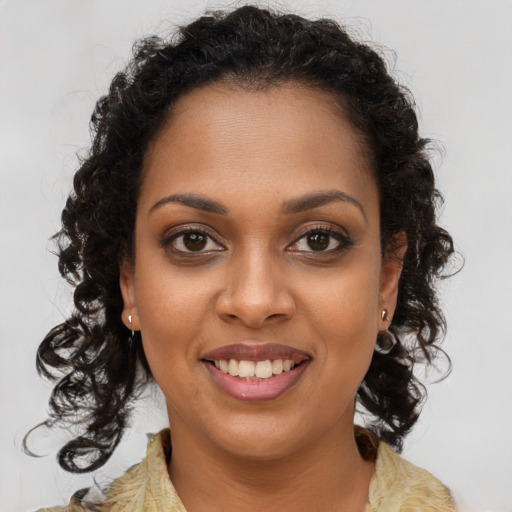 Joyful black young-adult female with long  brown hair and brown eyes