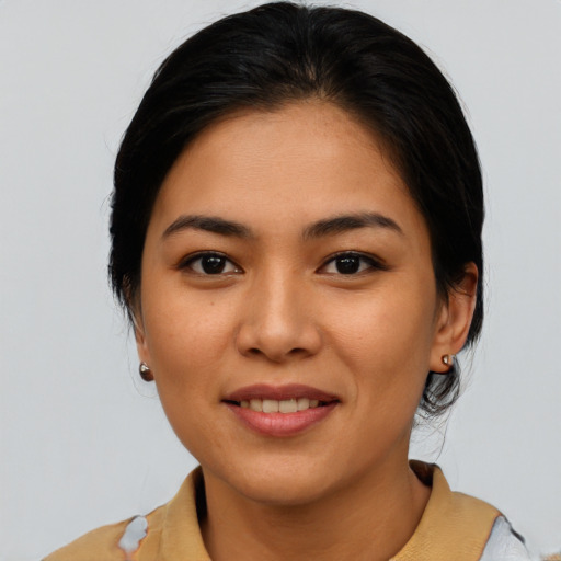 Joyful asian young-adult female with medium  brown hair and brown eyes