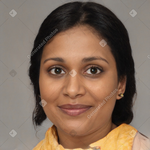 Joyful black adult female with medium  brown hair and brown eyes