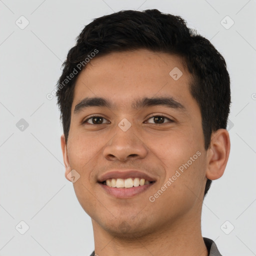 Joyful white young-adult male with short  black hair and brown eyes