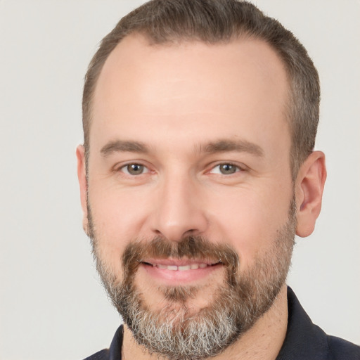 Joyful white adult male with short  brown hair and brown eyes