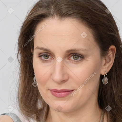 Joyful white adult female with long  brown hair and brown eyes