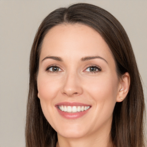 Joyful white young-adult female with long  brown hair and brown eyes