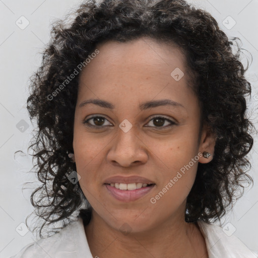 Joyful black young-adult female with long  brown hair and brown eyes